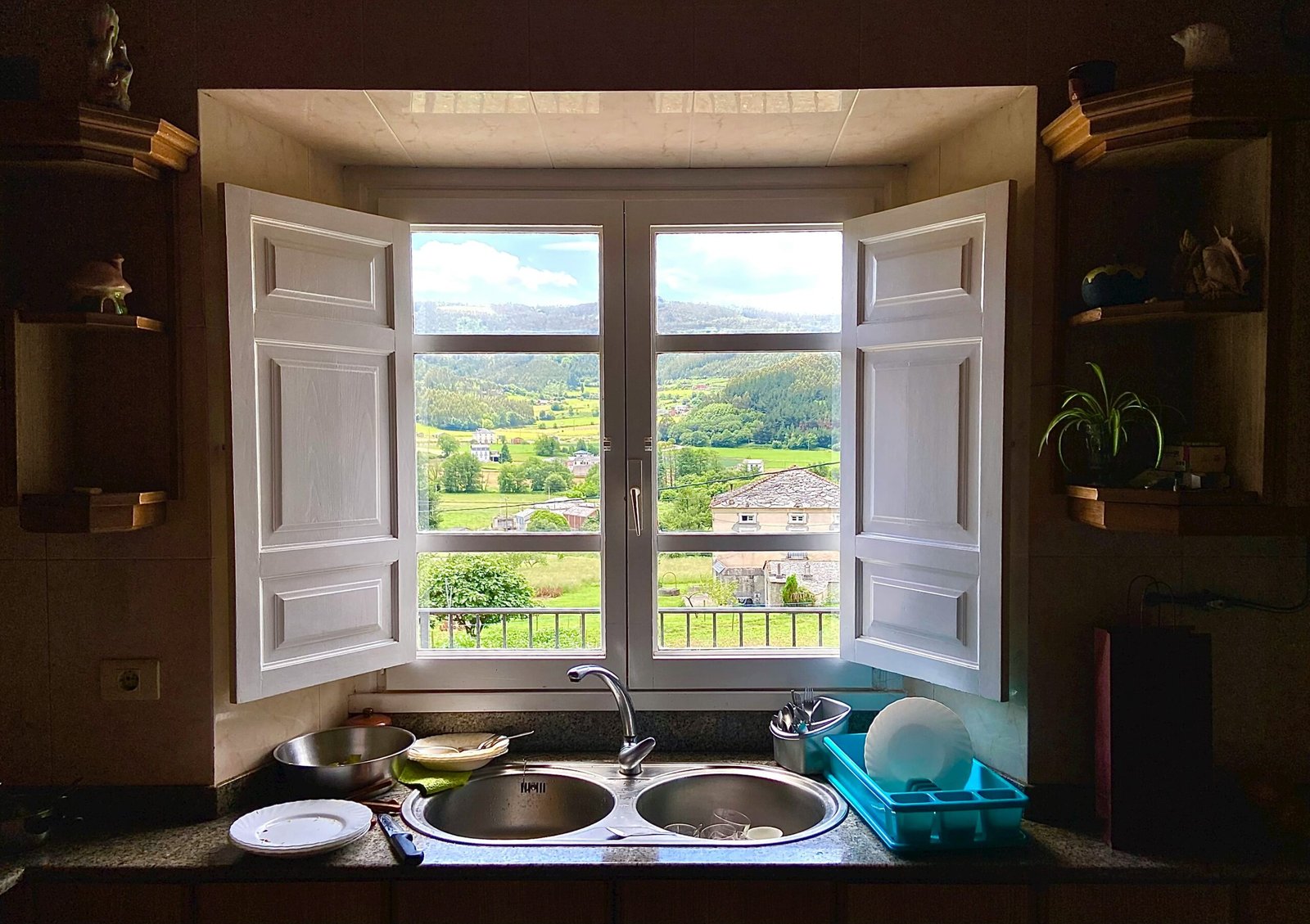 a kitchen with a double sink and open window